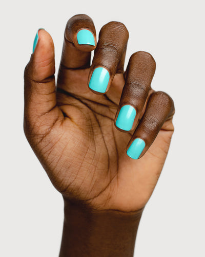 Turquoise aqua nail polish hand swatch on dark skin tone