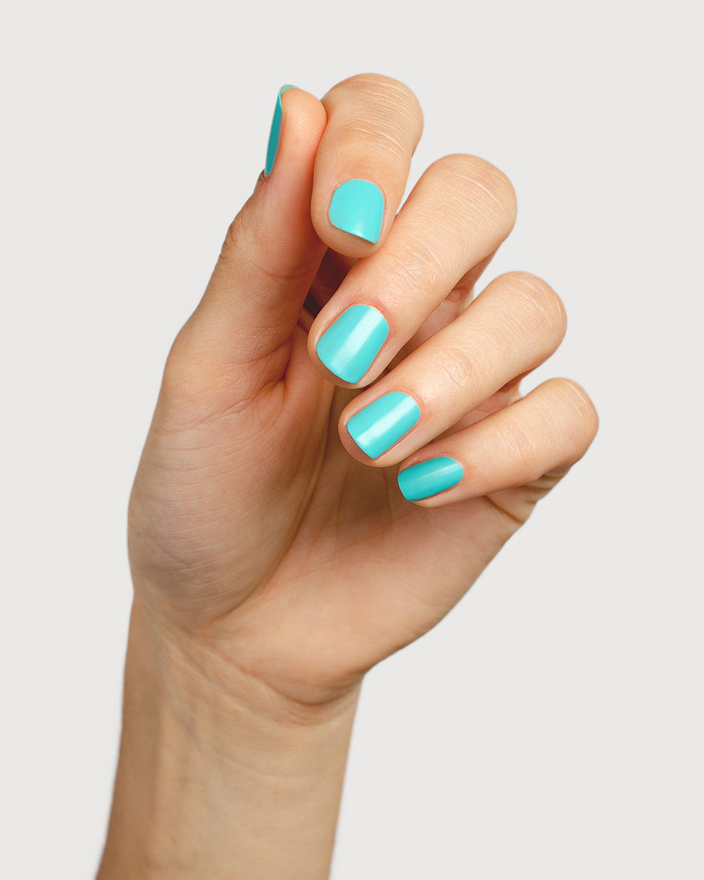 Turquoise aqua nail polish hand swatch on fair skin tone