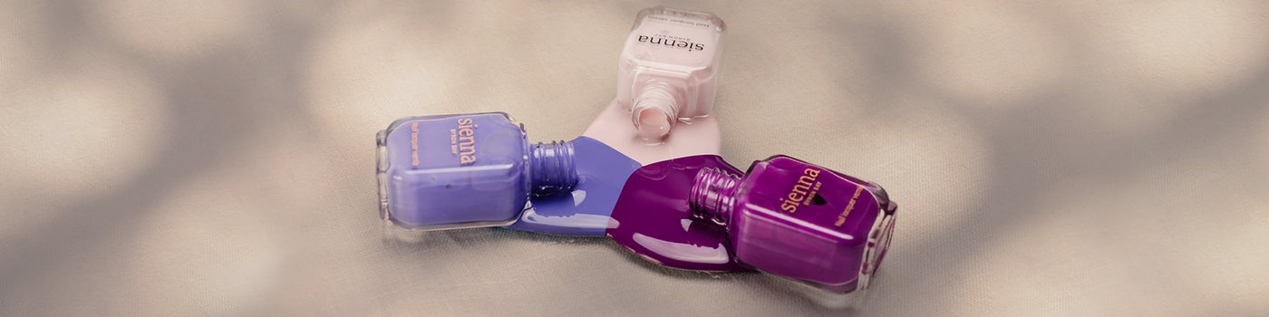 The Quiet Trio Gentle Midtone Blue Lilac Crème, Tranquility Light Mauve Rose Crème, nail polish bottles by Sienna Byron Bay.