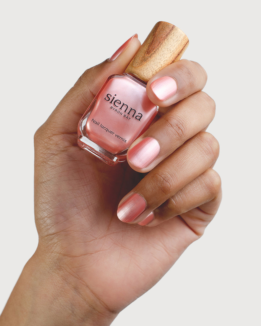 Warm Pink Satin Nail Polish on Medium Skin Tone with Glass Bottle 