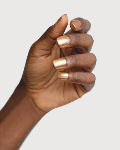 Solar Flare Gold Glaze nail polish hand swatch on dark skin tone