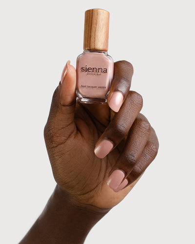 Dulcet Dark Skin Tone holding the glass bottle