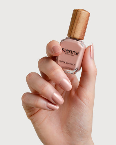 Dulcet Fair Skin Tone holding the glass bottle