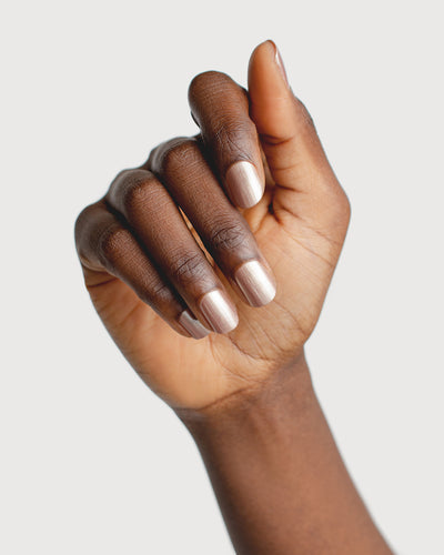 Rose brown with silver satin Glaze nail polish hand swatch on dark skin tone