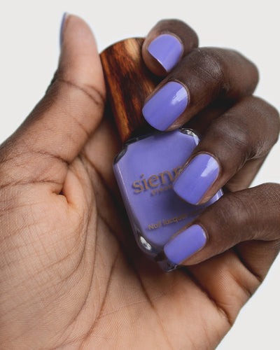 Gentle Midtone Blue Lilac Crème nail polish by Sienna Byron Bay on dark skin tone hand. 