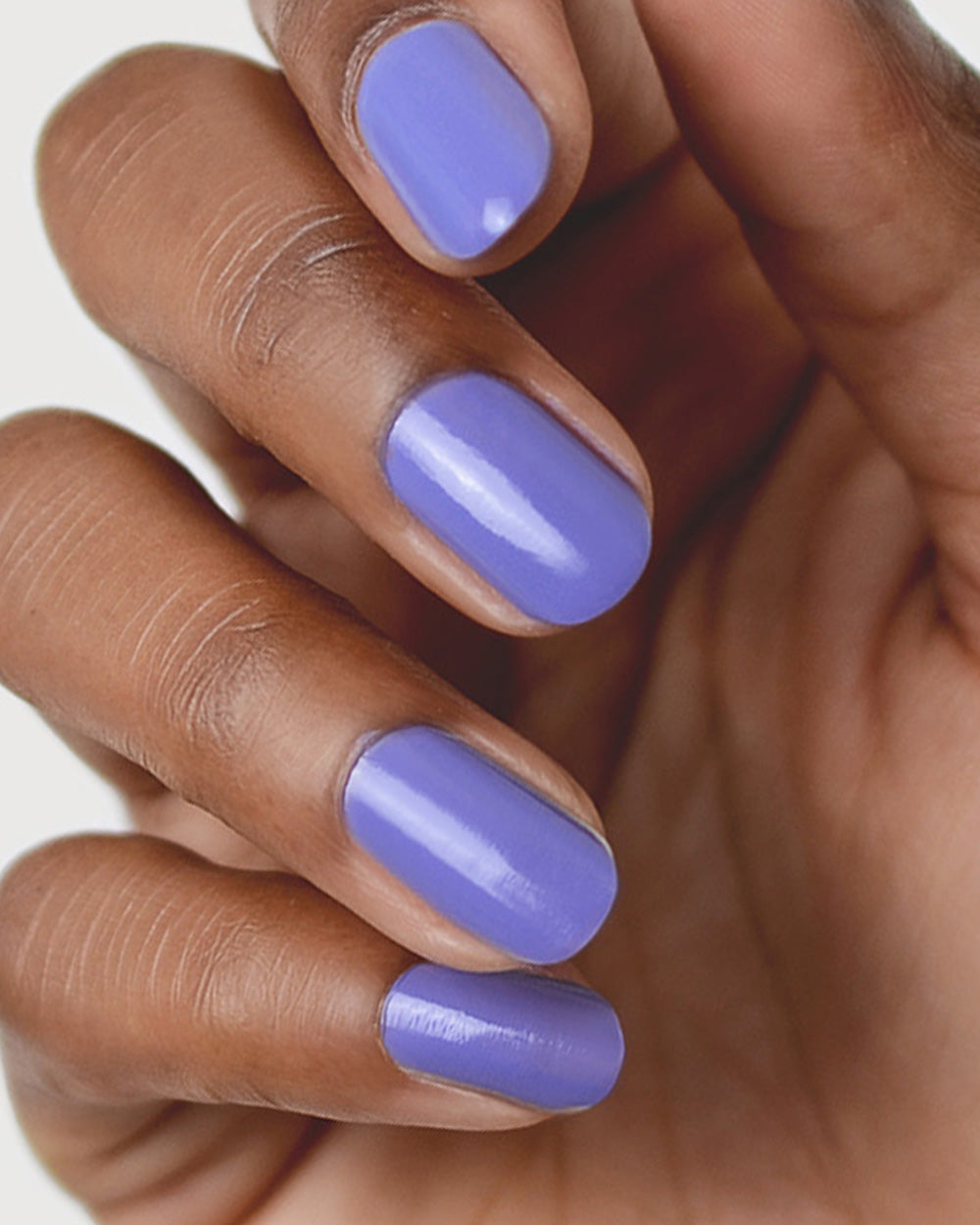 Gentle Midtone Blue Lilac Crème nail polish by Sienna Byron Bay on medium skin tone hand.