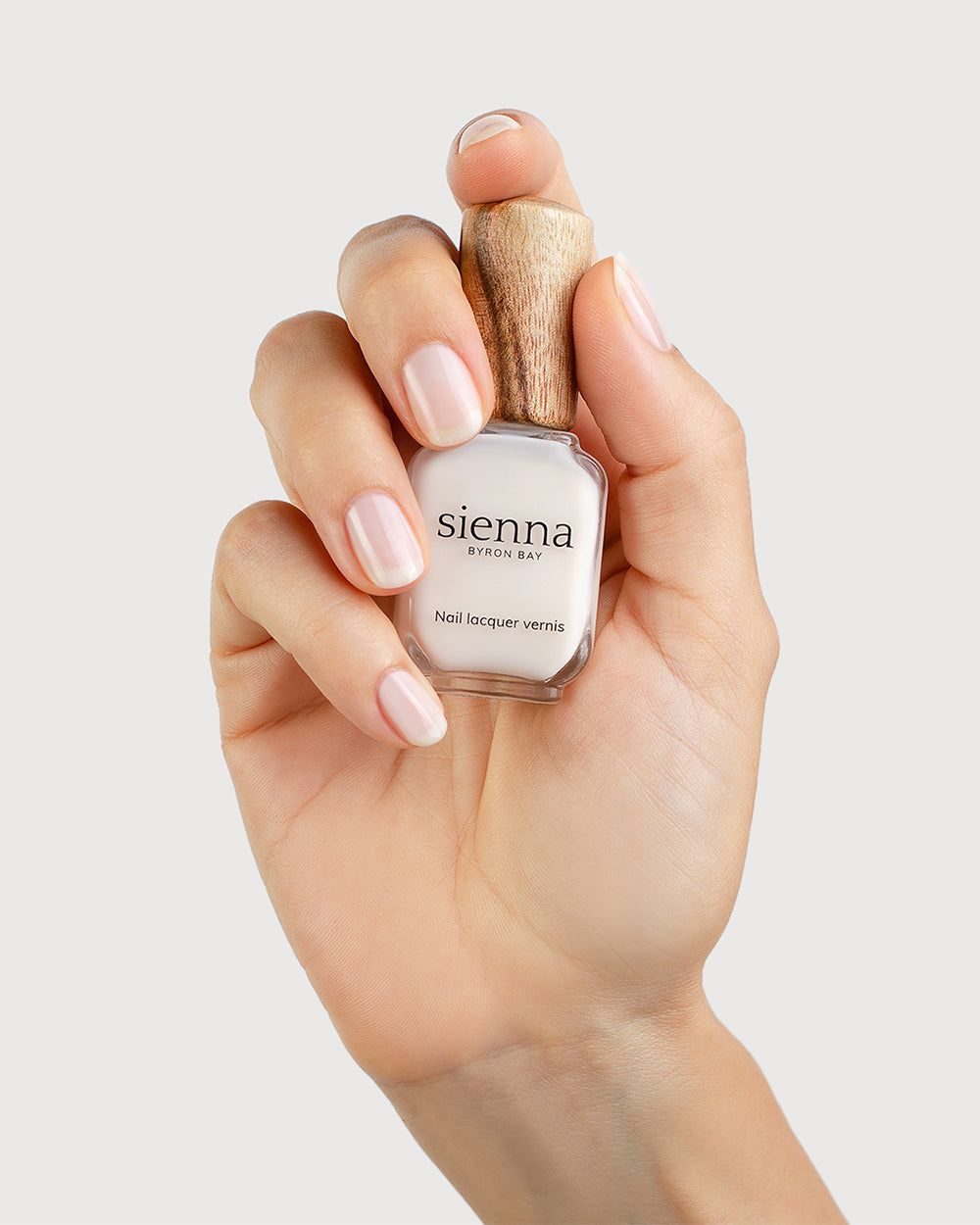 Milky Sheer White nail polish on fair skin tone with Sienna Bottle