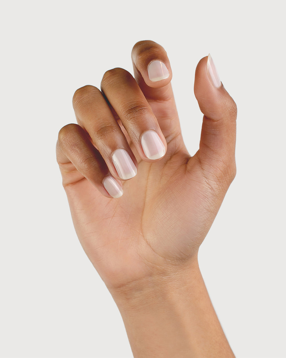 Milky Sheer White nail polish on medium skin tone