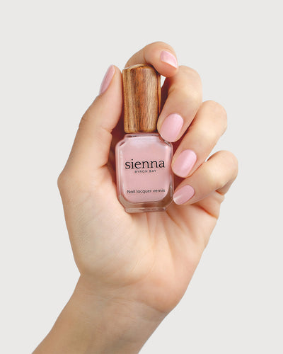 Shimmering Cherry Blossom Nail Polish on Fair Skin Tone with Sienna Bottle