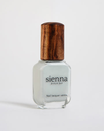 soft sage nail polish in a bottle with a timber lid