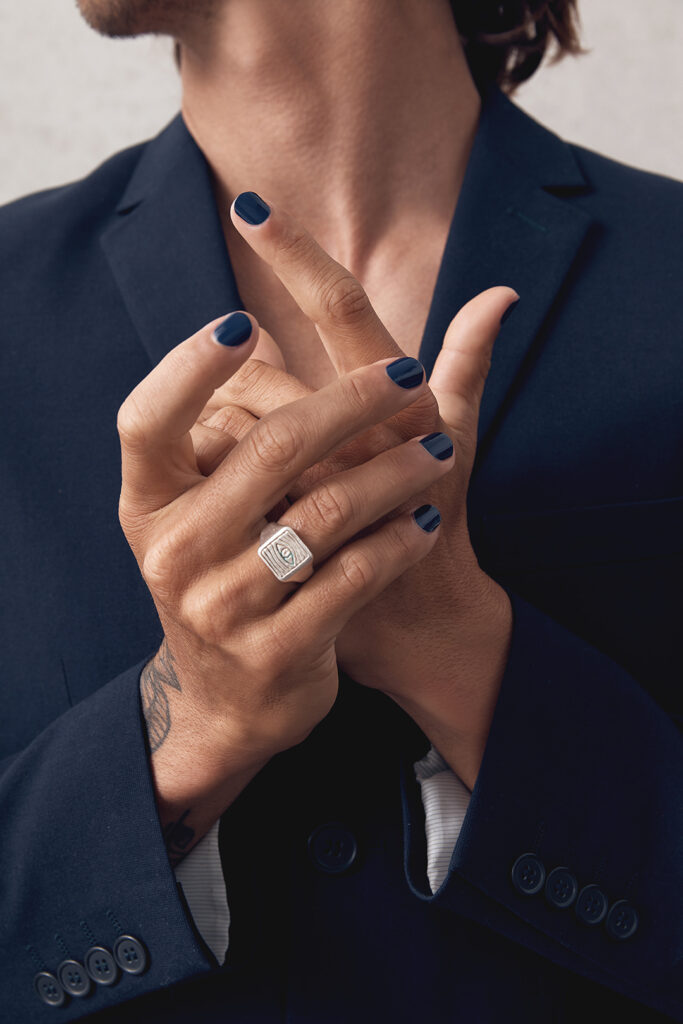 close up of man's hands wearing navy blue nail polish by sienna