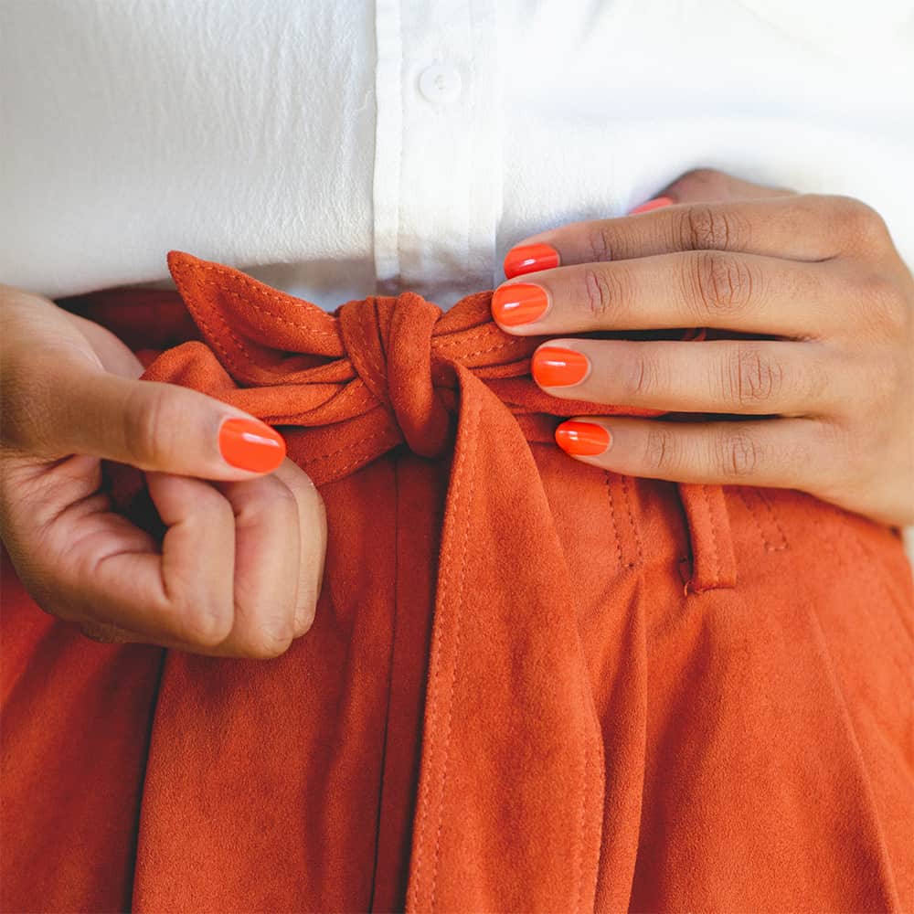 Tangerine orange nail polish hand swatch on medium skin tone by sienna
