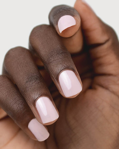Tranquility Light Mauve Rose Crème nail polish by Sienna Byron Bay on dark skin tone hand. 
