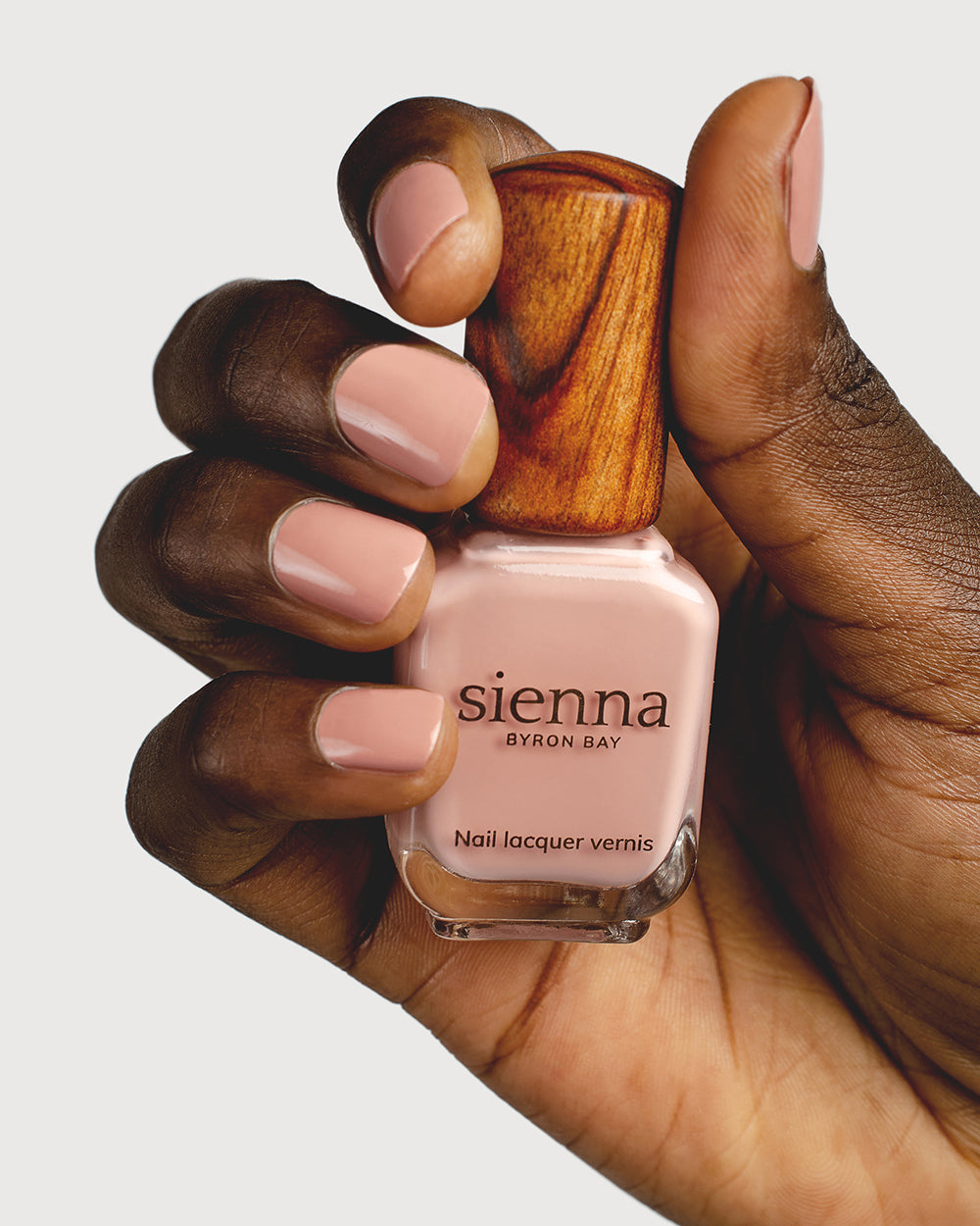 Dusty Rose nail polish on dark skin tone with Sienna Bottle up close