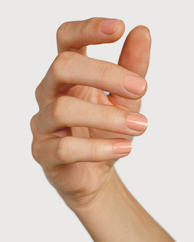 nude pink nail polish hand swatch on fair skin tone