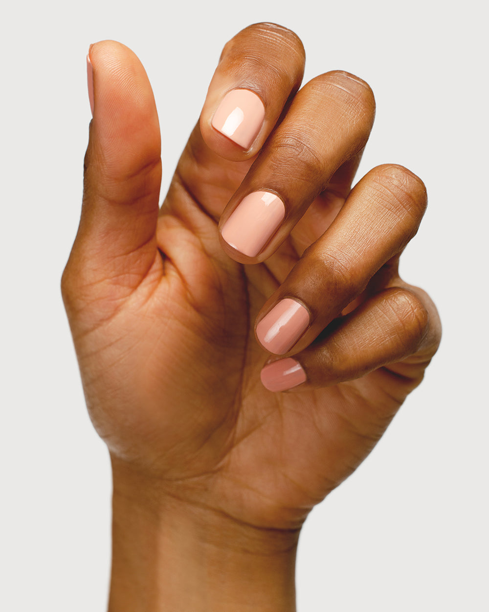 nude pink nail polish hand swatch on medium skin tone