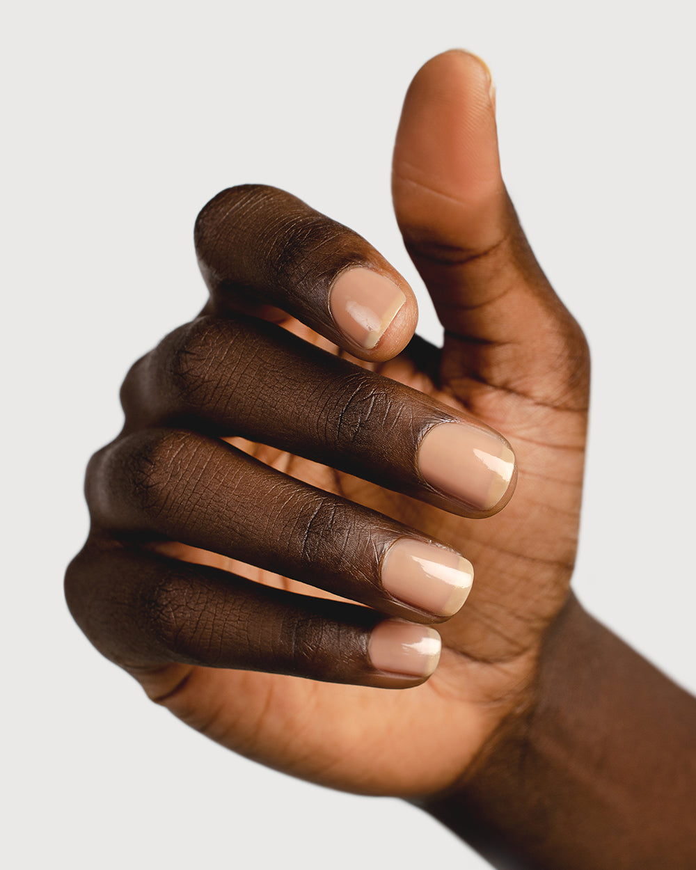 nude sheer nail polish hand swatch on dark skin tone