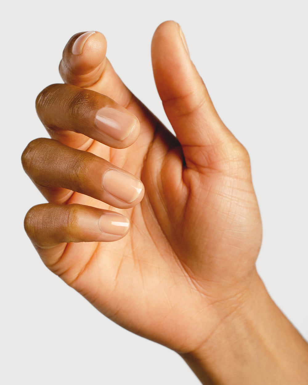 nude sheer nail polish hand swatch on medium skin tone