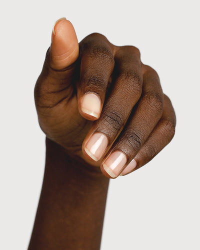 clear base coat nail polish hand swatch on dark skin tone
