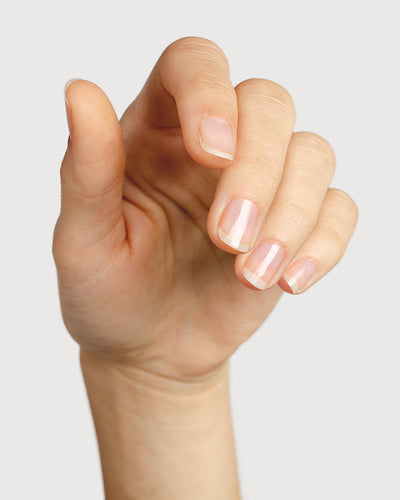 clear base coat nail polish hand swatch on fair skin tone