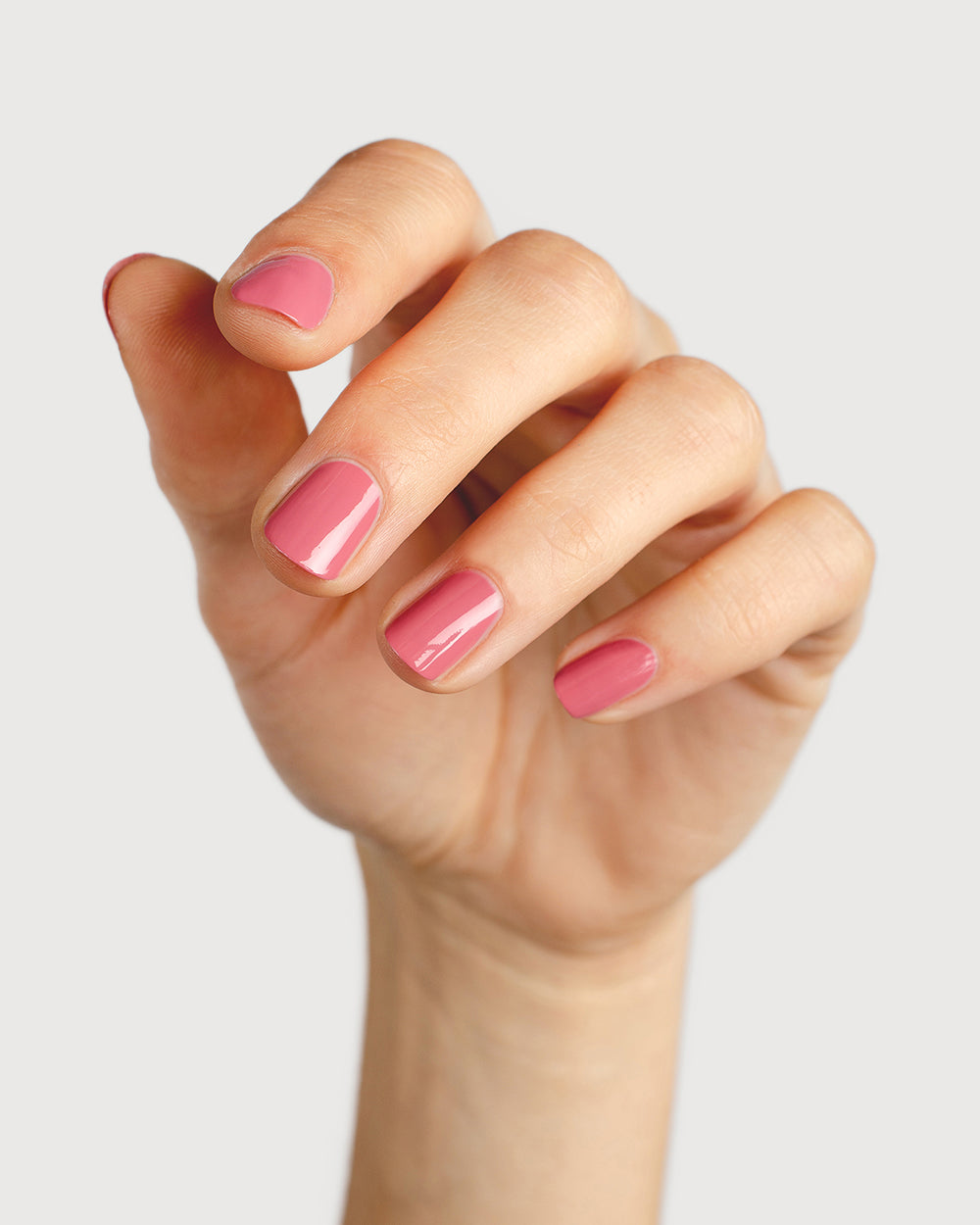 midtone pink nail polish hand swatch on fair skin tone