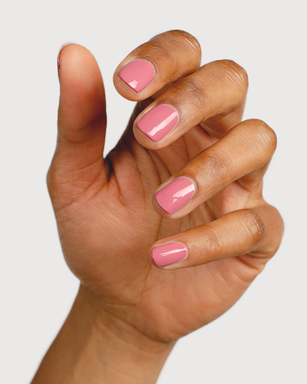 midtone pink nail polish hand swatch on medium skin tone