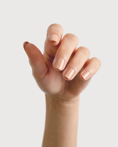 beige nude nail polish hand swatch on fair skin tone