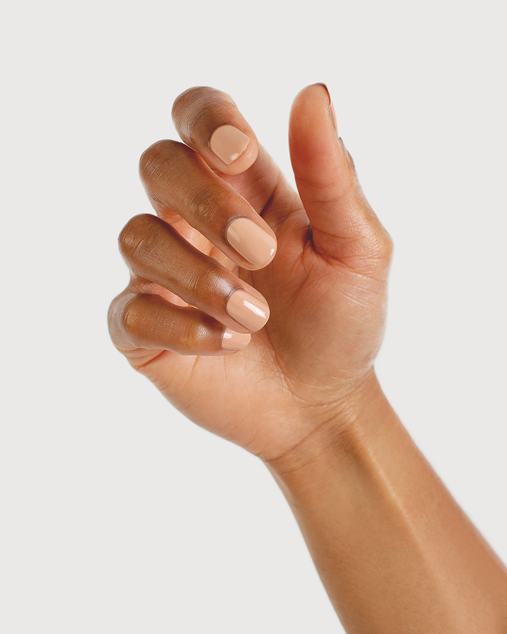 beige nude nail polish hand swatch on medium skin tone
