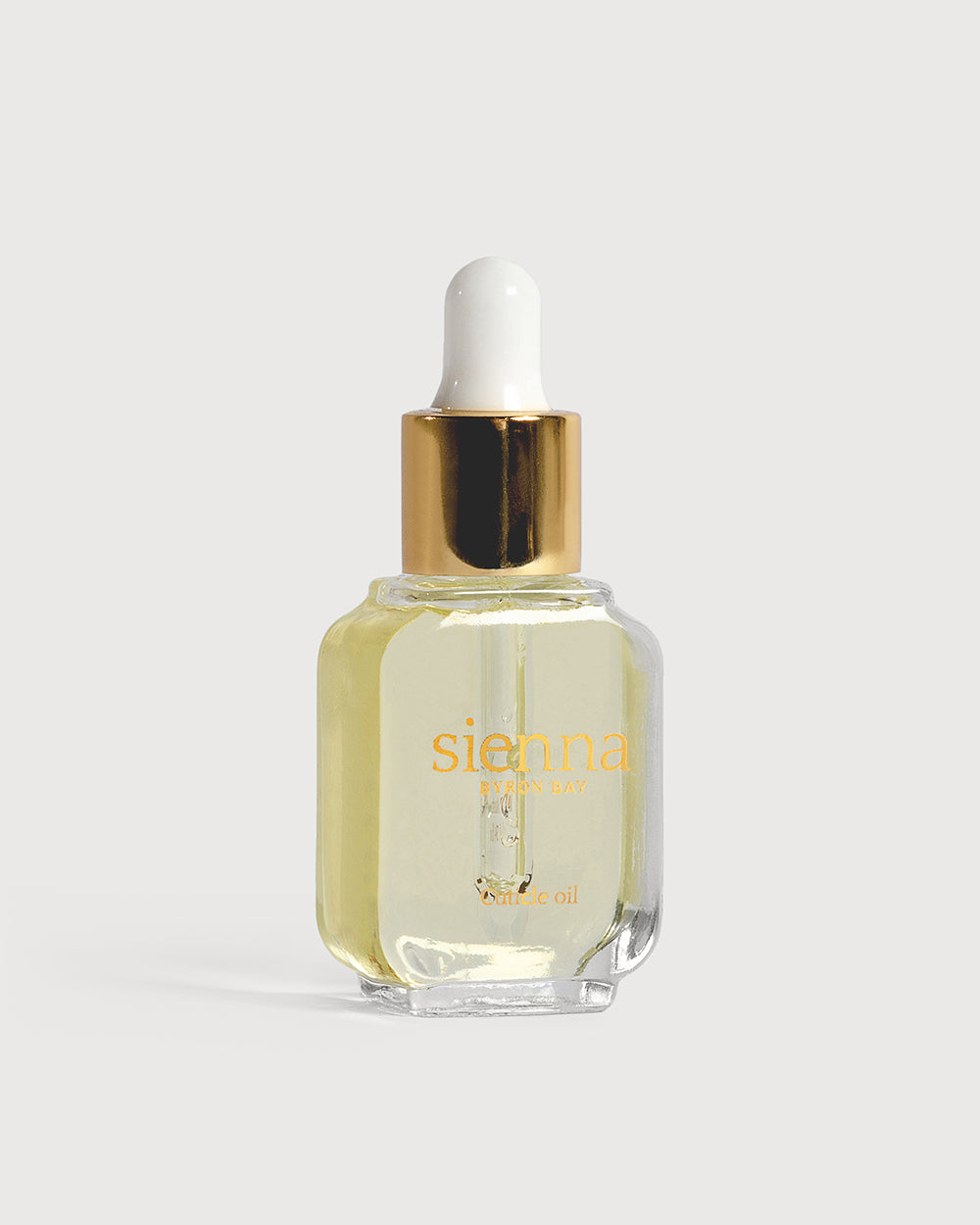 cuticle oil in glass bottle with dropper with gold top