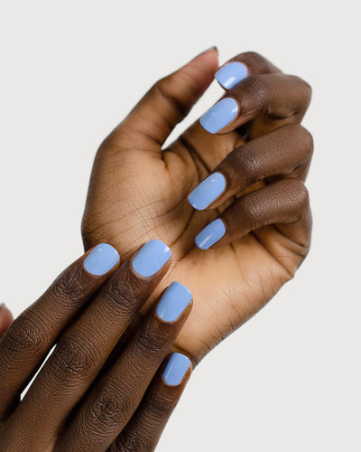 periwinkle blue nail polish hand swatch on dark skin tone