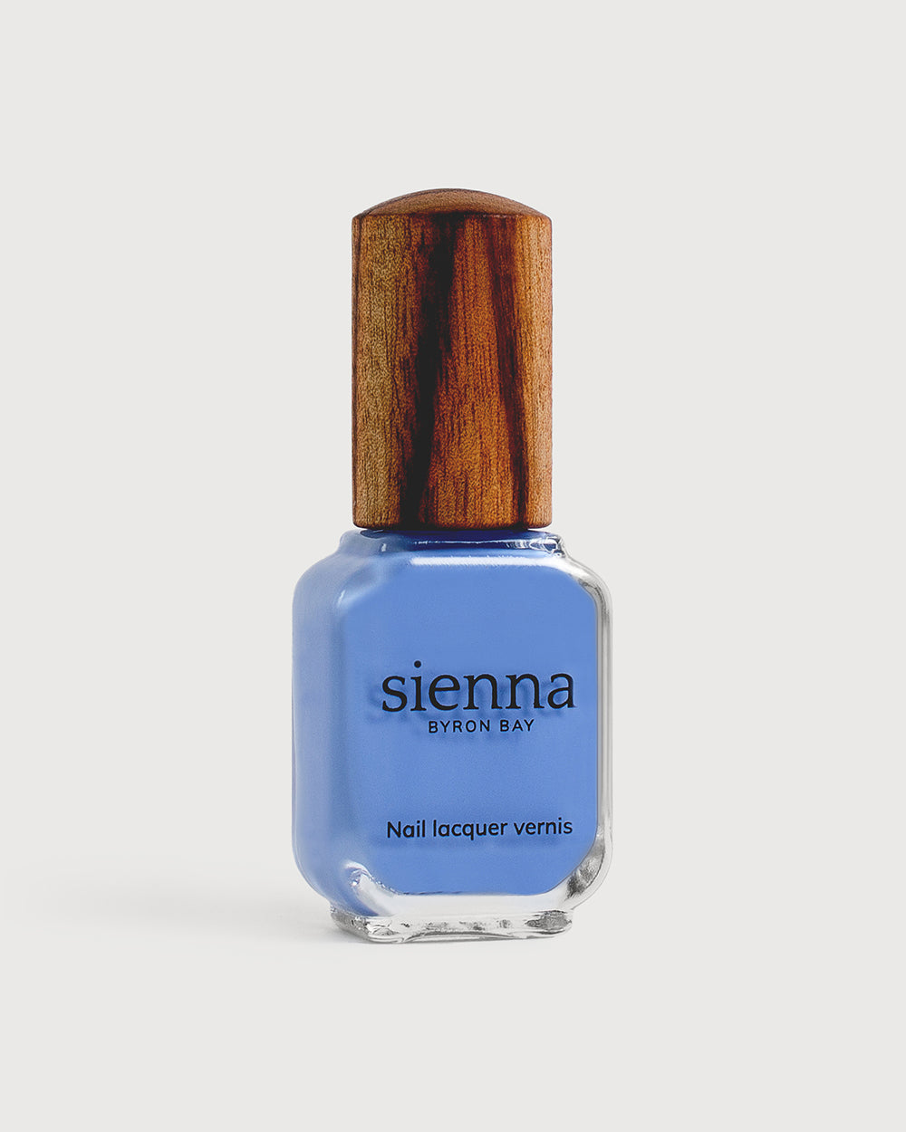  periwinkle blue nail polish in a bottle with a timber cap 