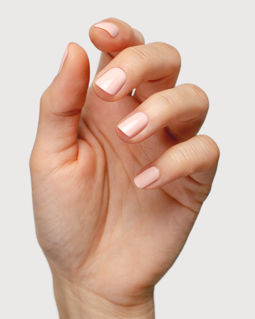 pastel pink nail polish hand swatch on fair skin tone