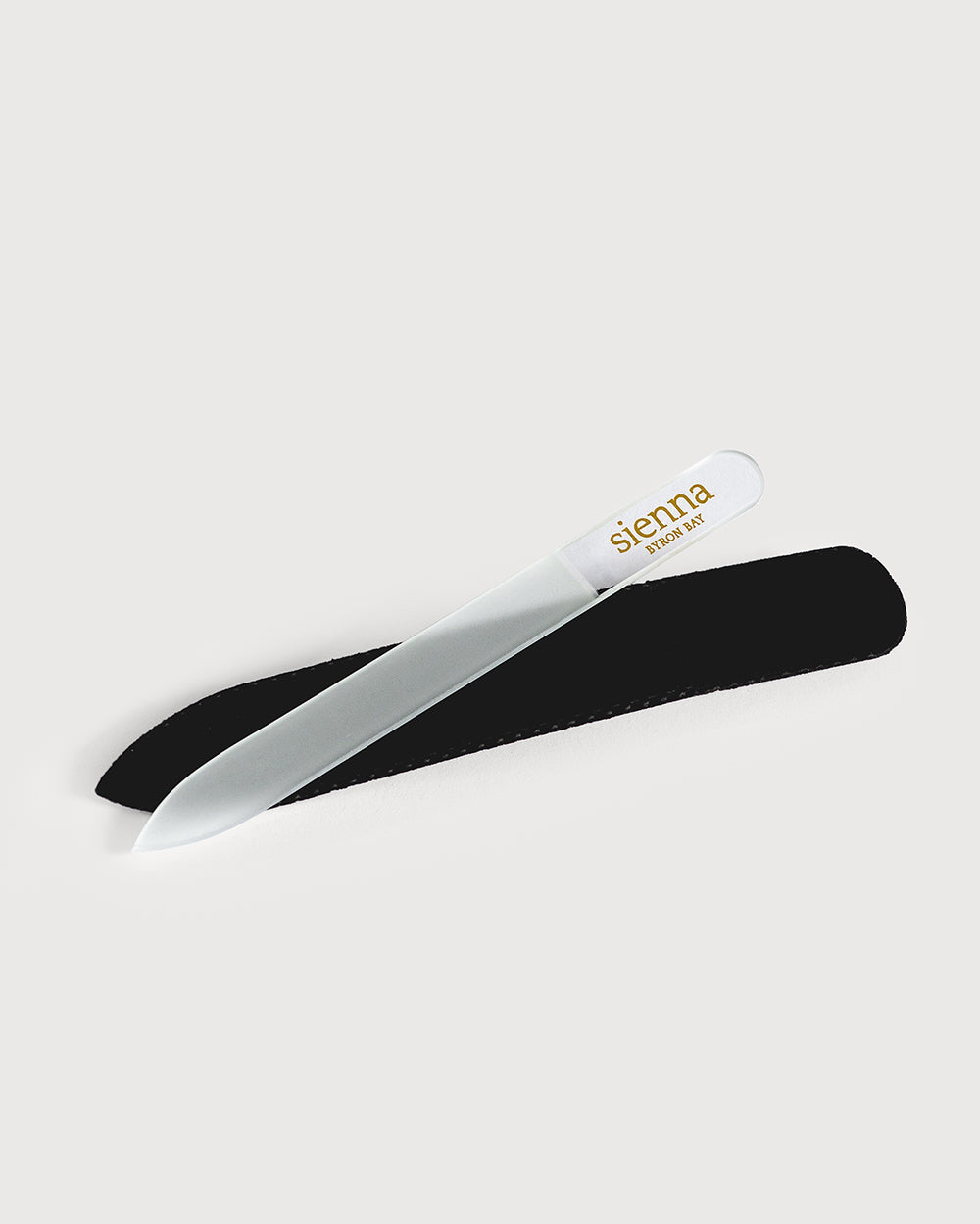 glass nail file on top of black sleeve by sienna