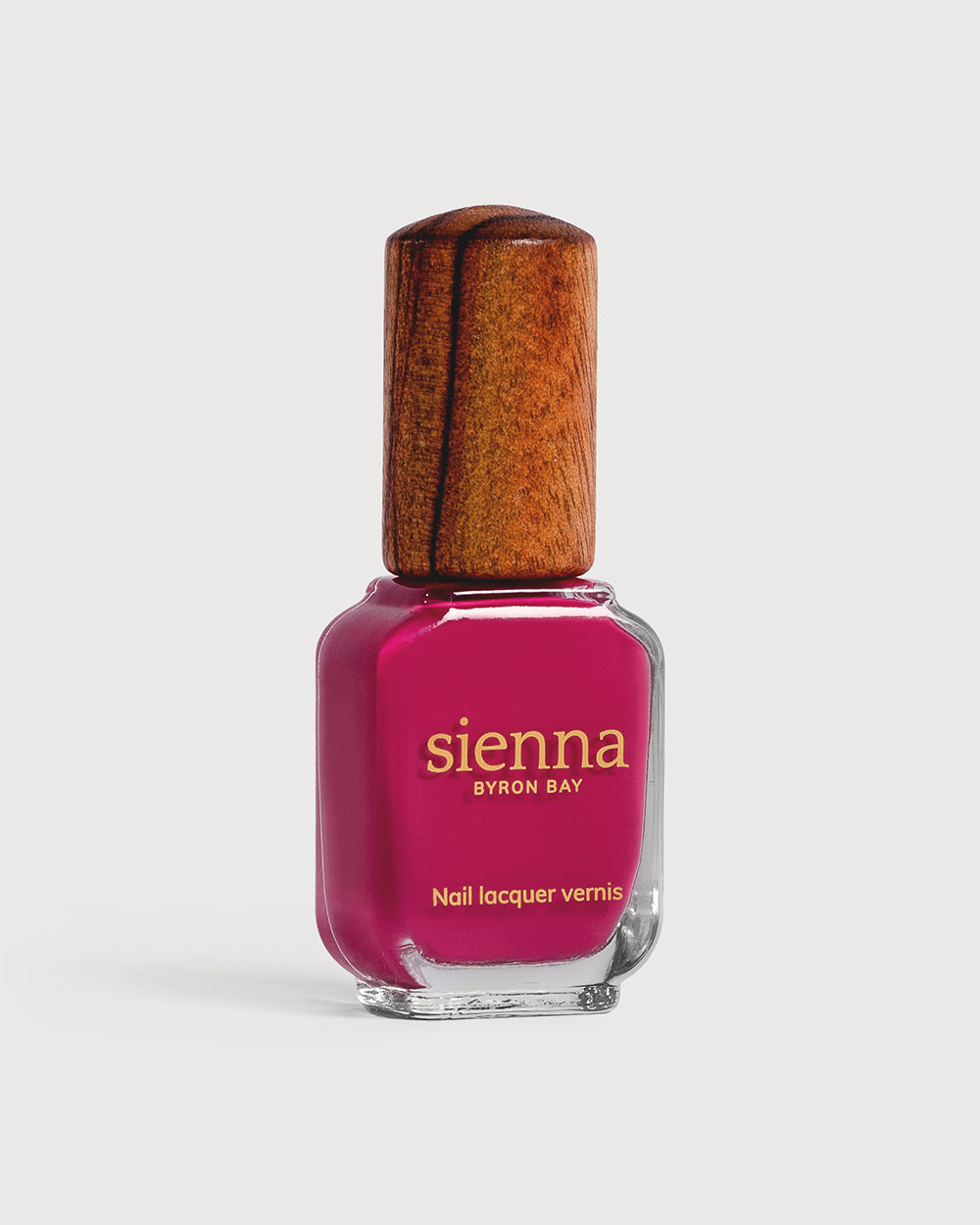 fushia pink nail polish bottle with timber cap