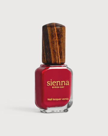 classic red nail polish bottle with timber cap