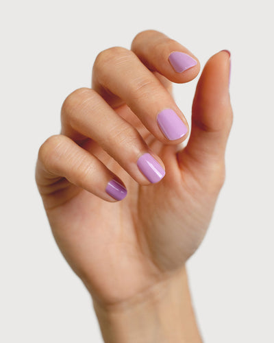Mid-tone lilac nail polish hand swatch on fair skin tone