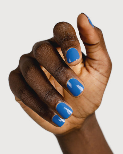 electric blue nail polish hand swatch on dark skin tone