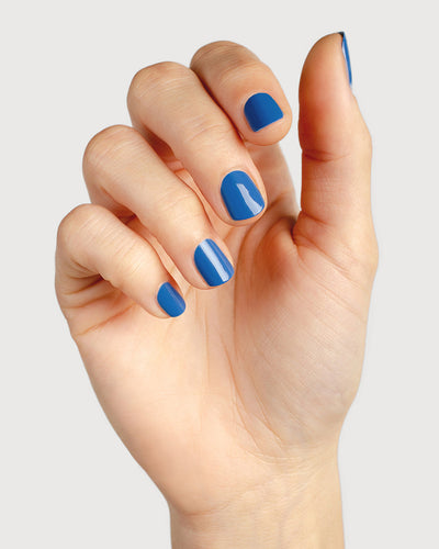 electric blue nail polish hand swatch on fair skin tone