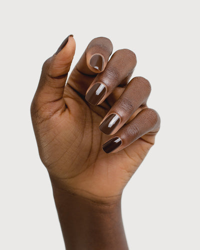 chocolate brown nail polish hand swatch on dark skin tone