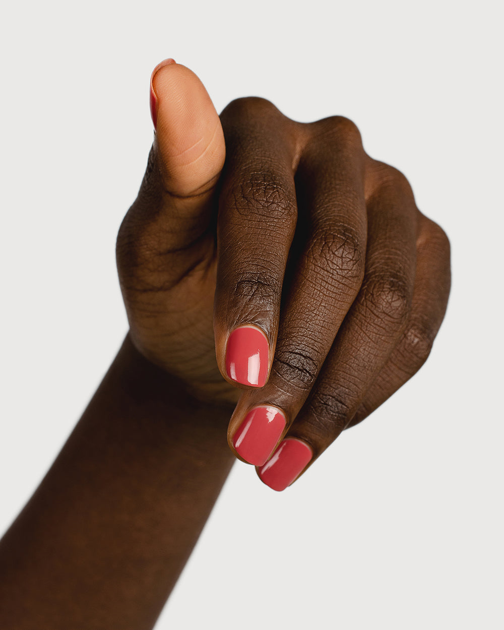 dusty rosebud nail polish hand swatch on dark skin tone