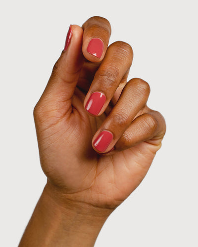 dusty rosebud nail polish hand swatch on medium skin tone