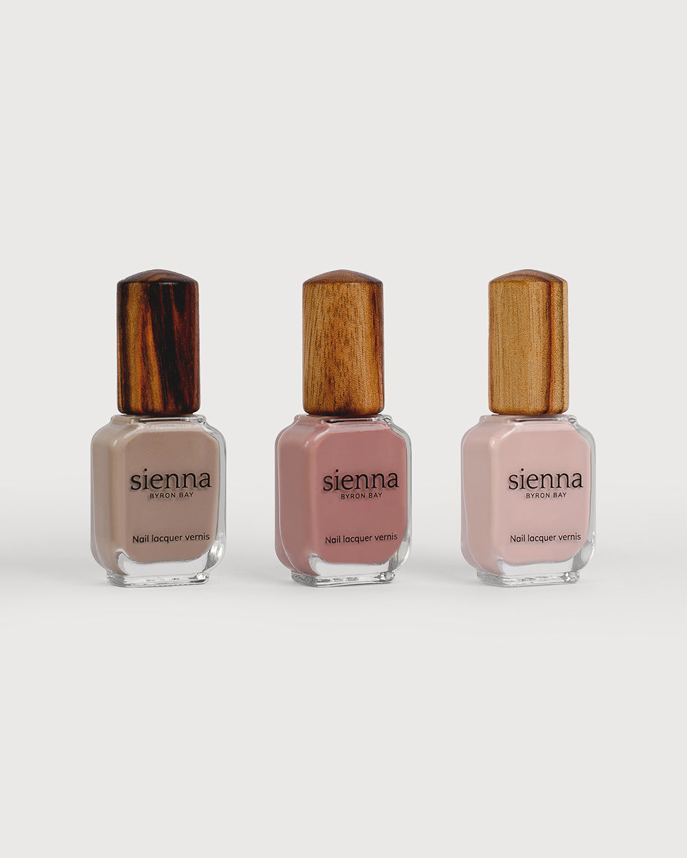 Warm clay, Stony mauve, Light champagne pink nail polish bottles with timber cap