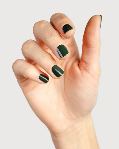 Deep olive green nail polish hand swatch on fair skin tone