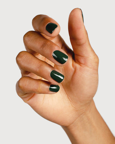 Deep olive green nail polish hand swatch on medium skin tone