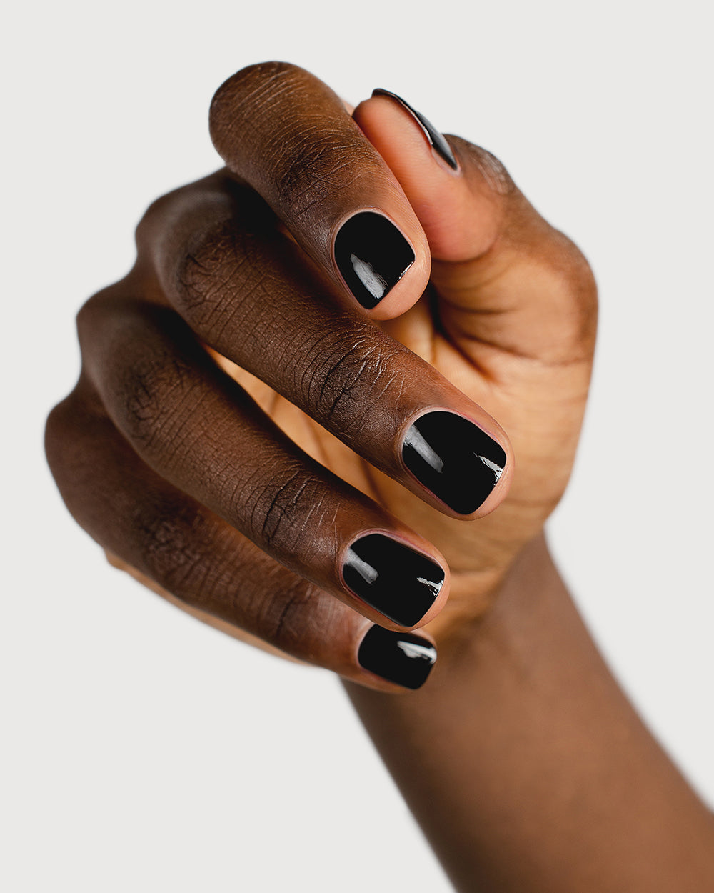 jet black nail polish hand swatch on dark skin tone