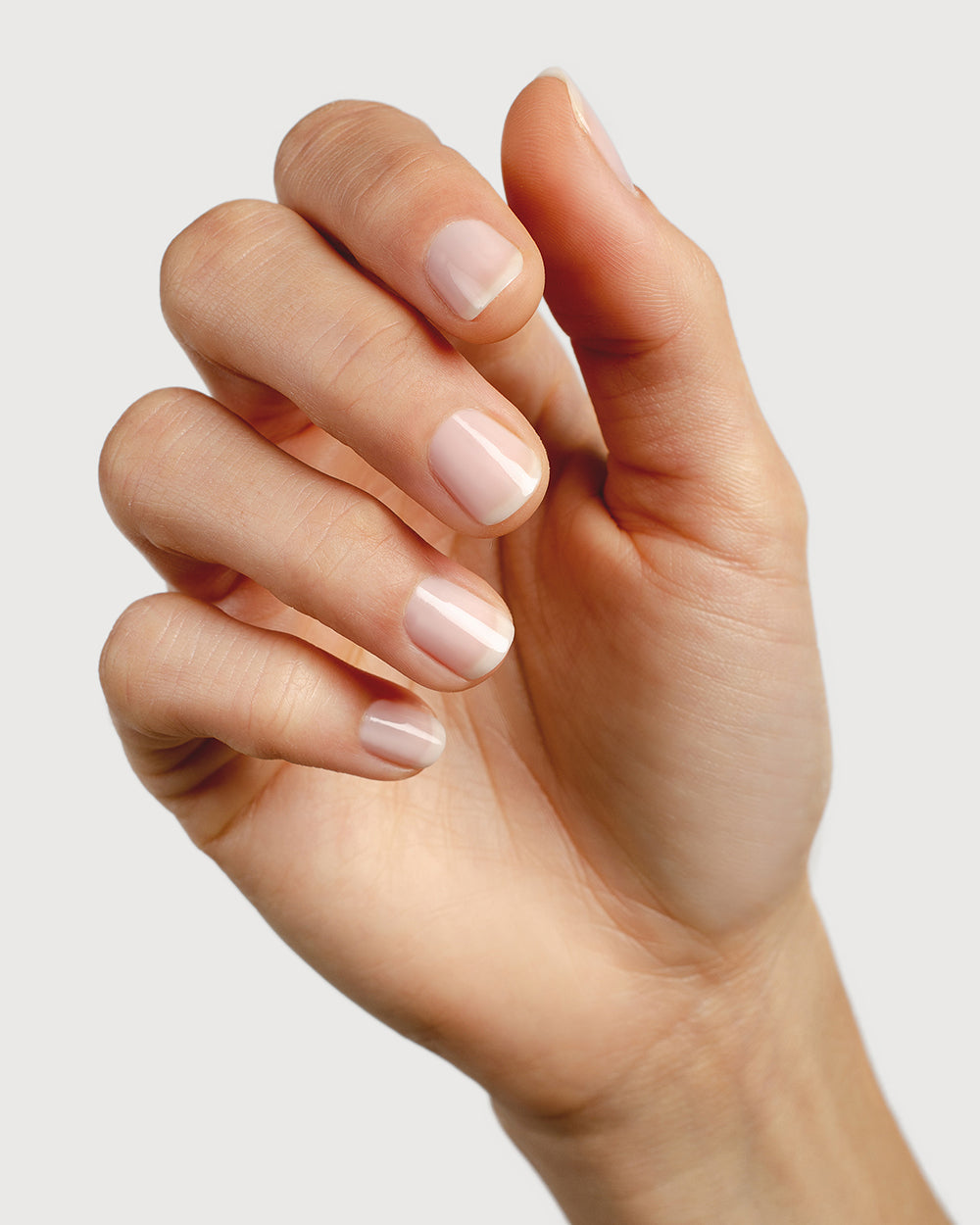 light rosewater pink sheer nail polish hand swatch on fair skin tone