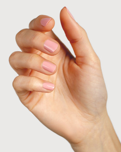 Cherry blossom pink nail polish hand swatch on fair skin tone