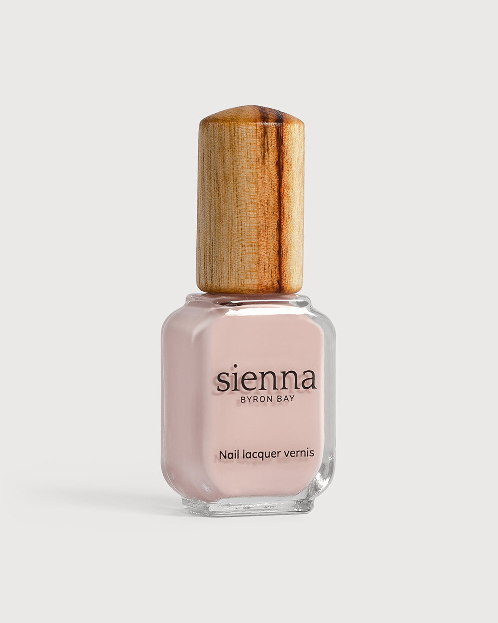 Light champagne pink nail polish glass bottle with timber cap