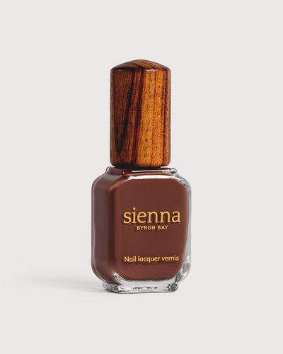 Deep burnt umber nail polish glass bottle with timber cap