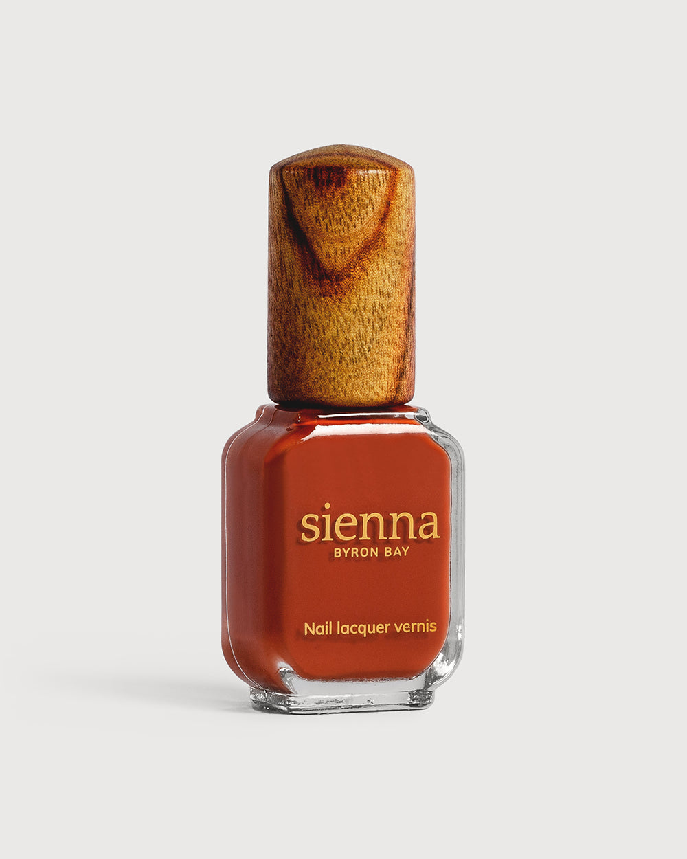 Deep terracotta nail polish glass bottle with timber cap